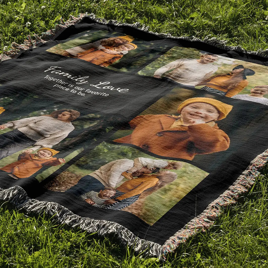 Personalized photo blanket with fringed edges spread out on green grass in natural daylight.