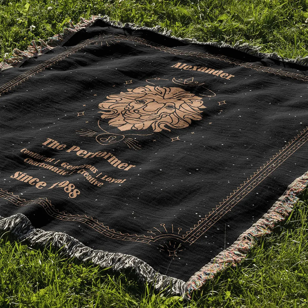 Custom zodiac-themed blanket laid out on grass with Leo constellation-style design, with custom name and year.