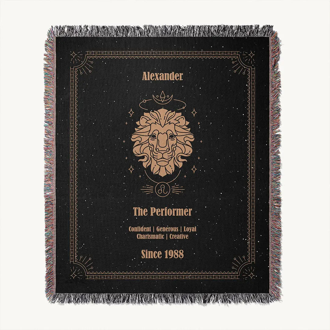 Flat lay of a custom Leo zodiac woven cotton blanket on a white background, highlighting the centered lion symbol, decorative frame, and custom text.