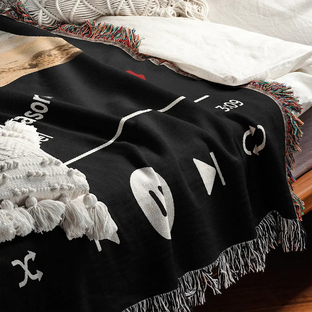 Personalized music player woven cotton blanket for couples, displayed on a bed with pillows for a cozy bedroom look.