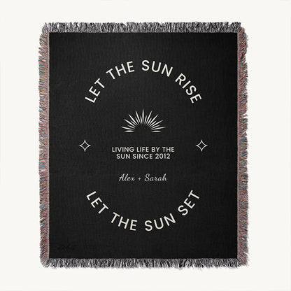 Full view of custom woven cotton name blanket for couples, with white celestial accents and sun design woven into a black cotton background and custom names.