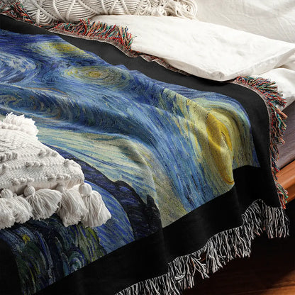 Close-up of "The Starry Night" woven cotton blanket draped on a bed, showcasing the detailed texture of the iconic swirling night sky artwork by Vincent van Gogh.