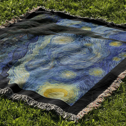 "The Starry Night" woven cotton blanket laid out on grass, highlighting the full composition of van Gogh’s famous painting with vivid stars and flowing brushstrokes.