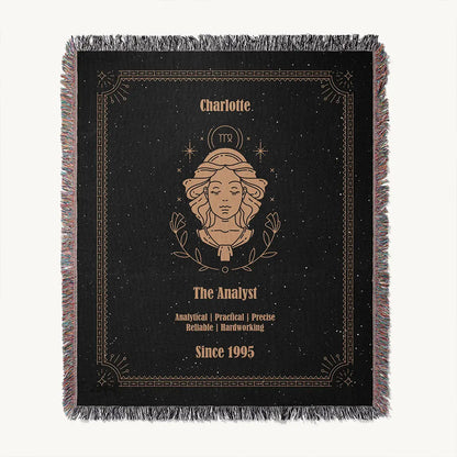 Flatlay of the Virgo zodiac custom woven cotton blanket, presenting a centered feminine illustration, a custom name, and associated traits on a black starry background.